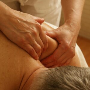 Close-up of a therapist giving a relaxing shoulder massage, enhancing wellness and stress relief.